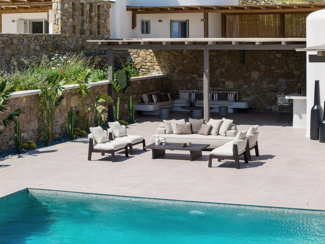 The pool and its loungers set among dry-stone walls and planting