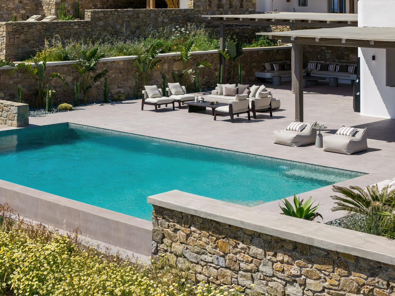 The pool laid into the slope, a dry-stone wall holding the terrace
