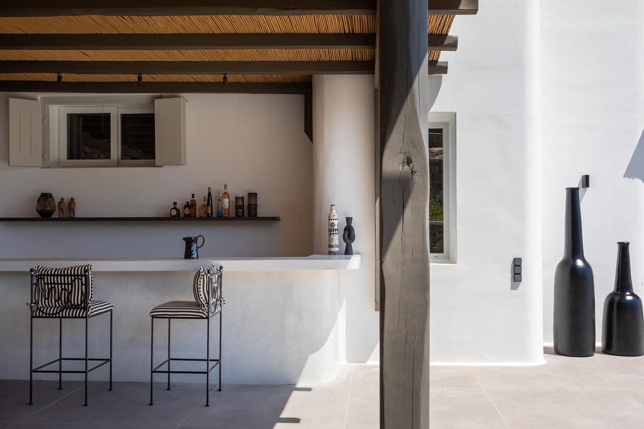 The stone bar beneath the bamboo ceiling, shutters open behind