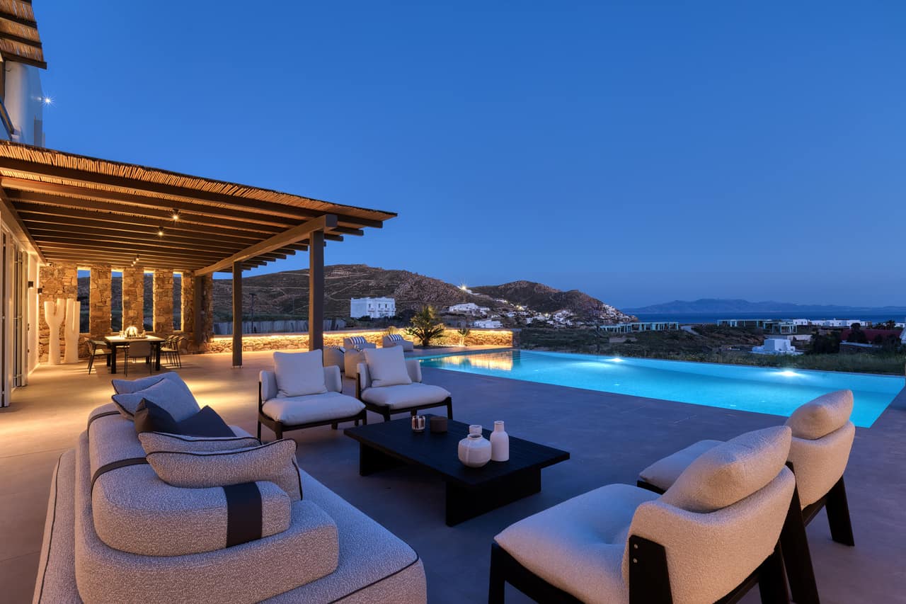 The terrace and pool at blue hour, the Aegean fading to night