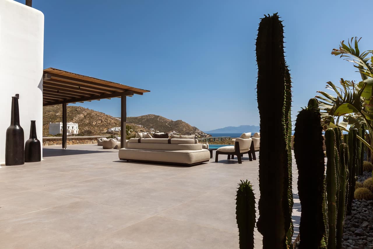 The long terrace and its daybed, cactus framing the open view
