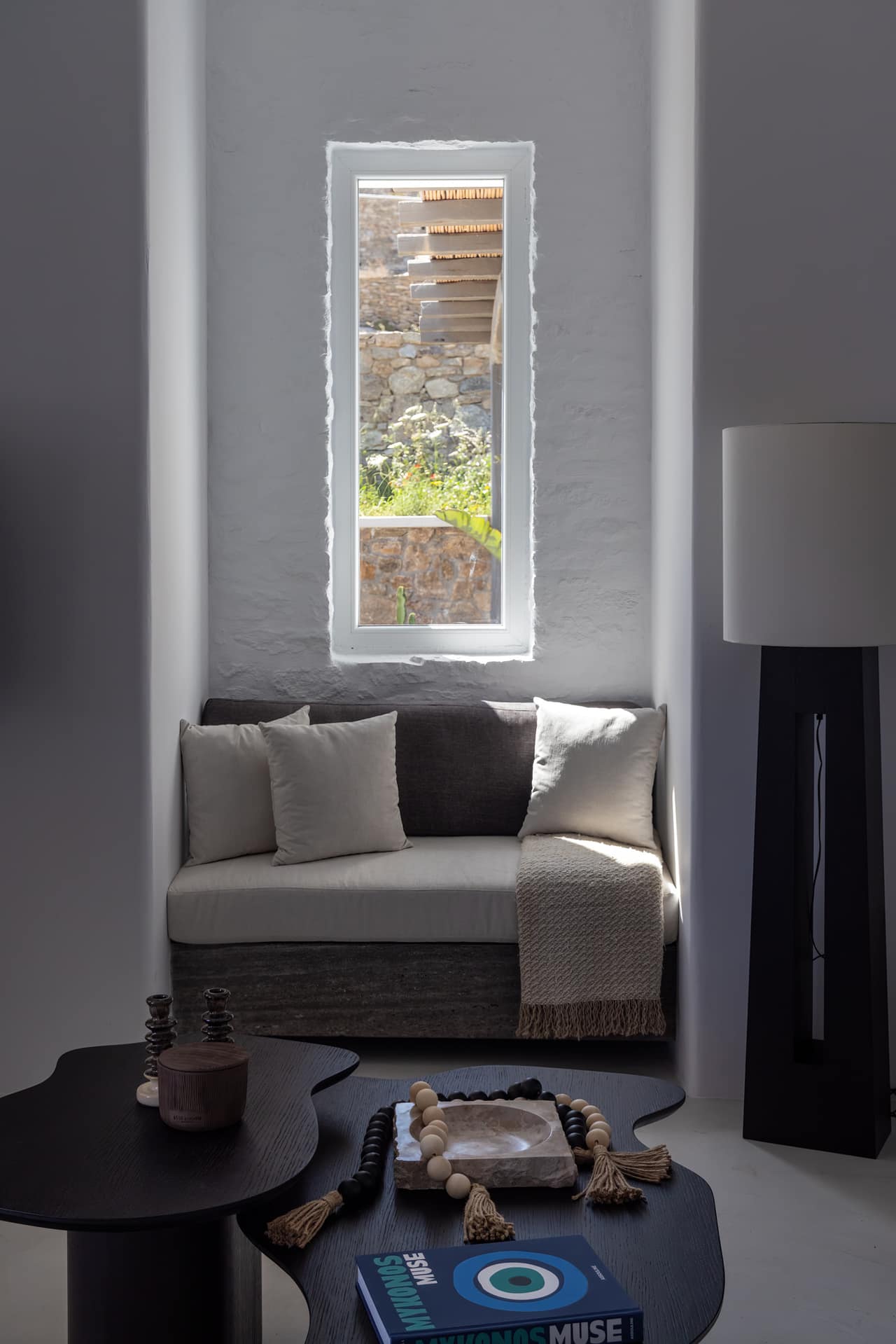 A window seat carved into the wall, the stone garden beyond
